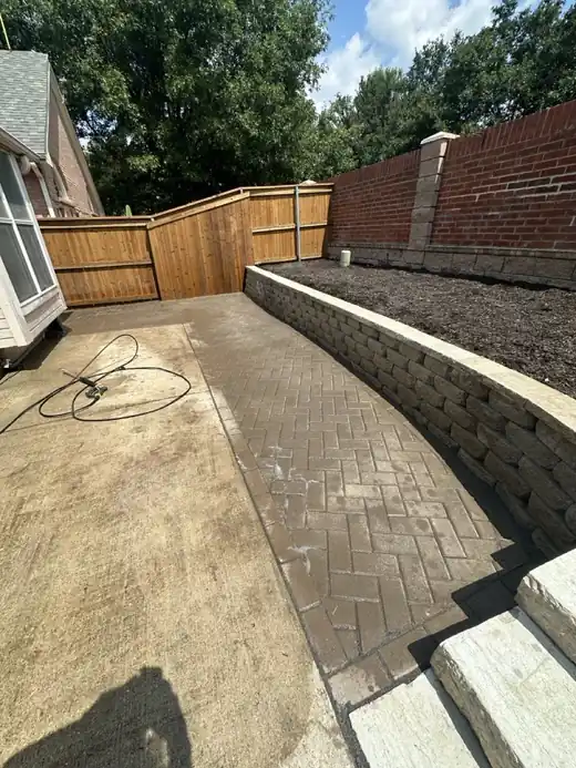 Finished paver walkway beside a block retaining wall